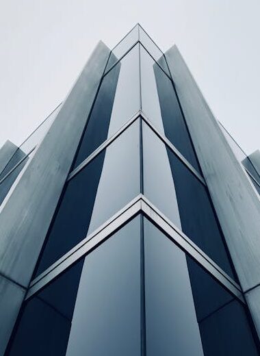 Low-angle shot of a sleek, modern skyscraper in Zürich, showcasing its glass and steel exterior.